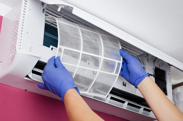 Emergency HVAC repair technician replacing air filters during urgent heating and cooling service call
