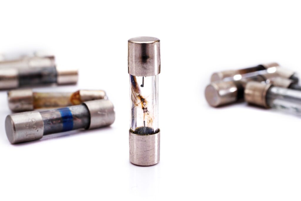 HVAC system fuse panel showing blown fuses causing air conditioner malfunction.